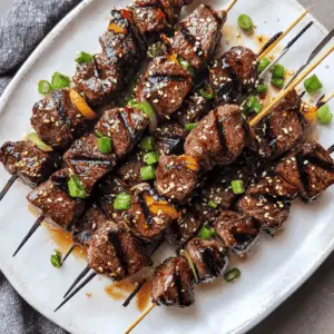 These Asian Garlic Steak Skewers are bursting with flavor! Tender marinated steak, grilled to perfection, and packed with garlic and a hint of soy sauce will delight your taste buds. Perfect for summer BBQs or a quick weeknight dinner. Save this recipe now for your next gathering or family meal!