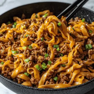 Satisfy your hunger with these delicious Mongolian Ground Beef Noodles! Made with perfectly seasoned ground beef, fresh veggies, and noodles, this dish comes together in no time. It's a fantastic weeknight dinner option that's sure to please everyone at the table. Save this recipe for your next family meal or dinner party!